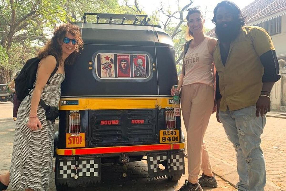 a group of three people standing in front of a truck