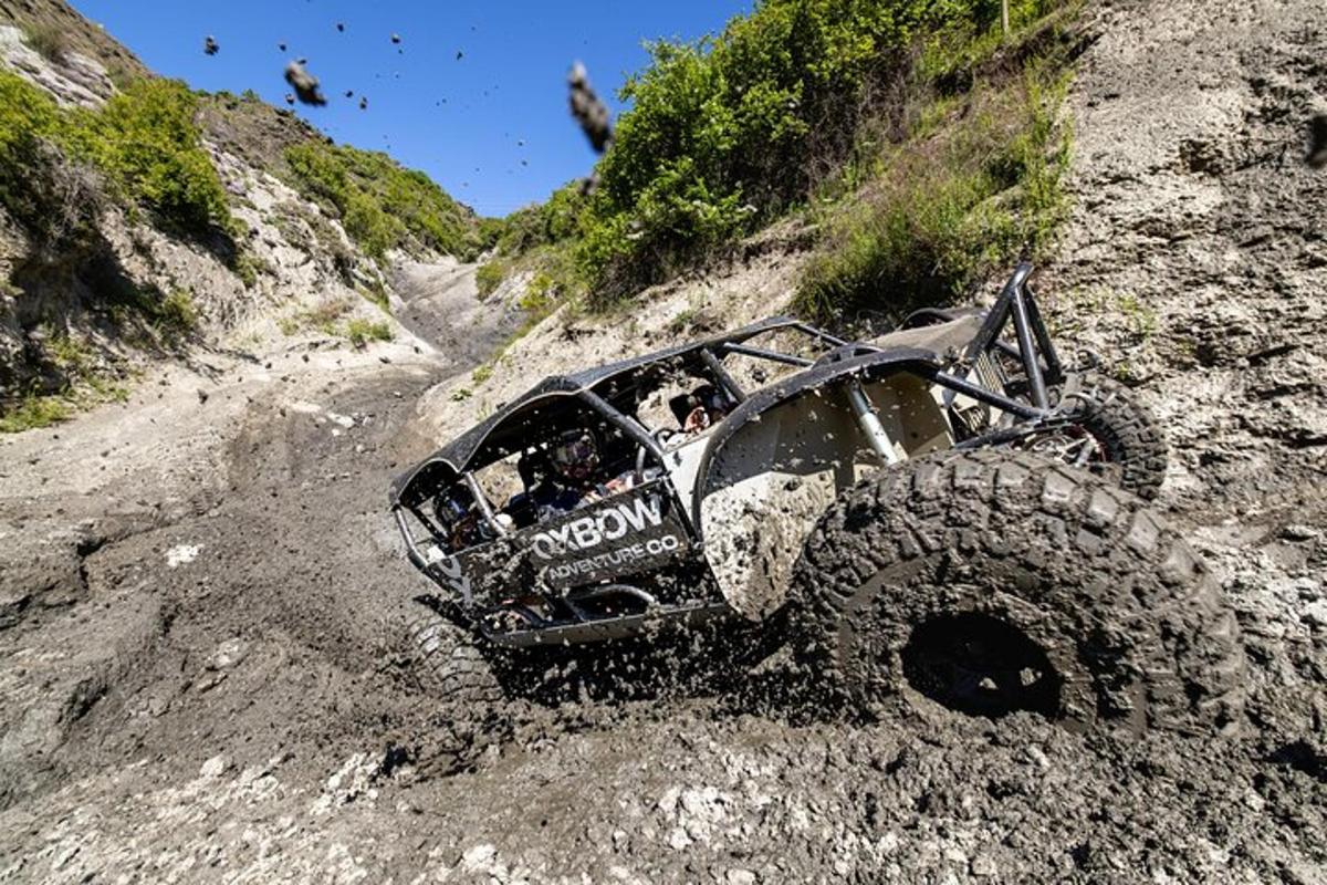 an off road vehicle is driving on a dirt road
