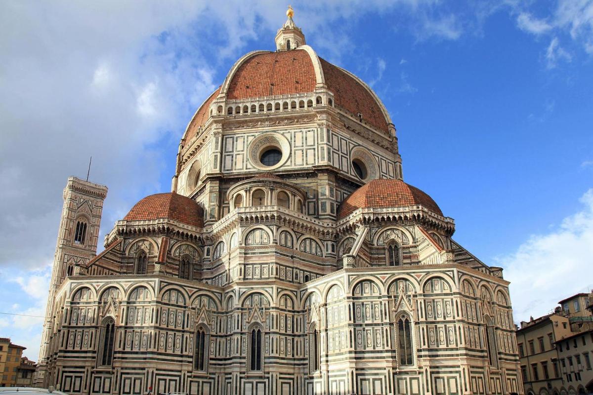 a large building with a tower with a dome