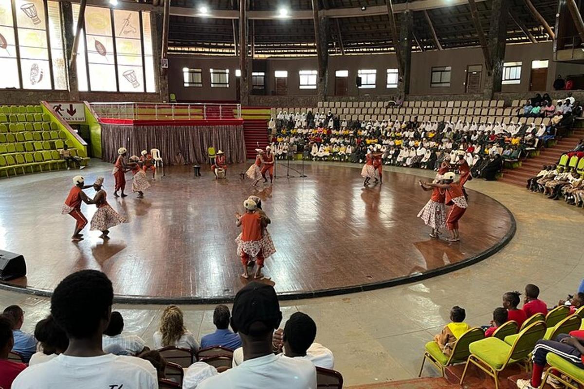 a crowd of people watching a group of dancers in a gym