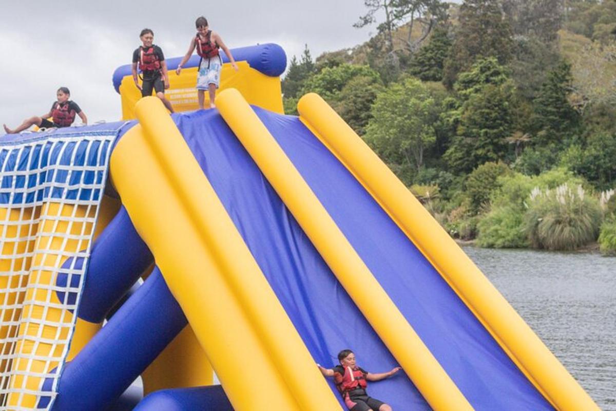 a group of people riding on an inflatable slide