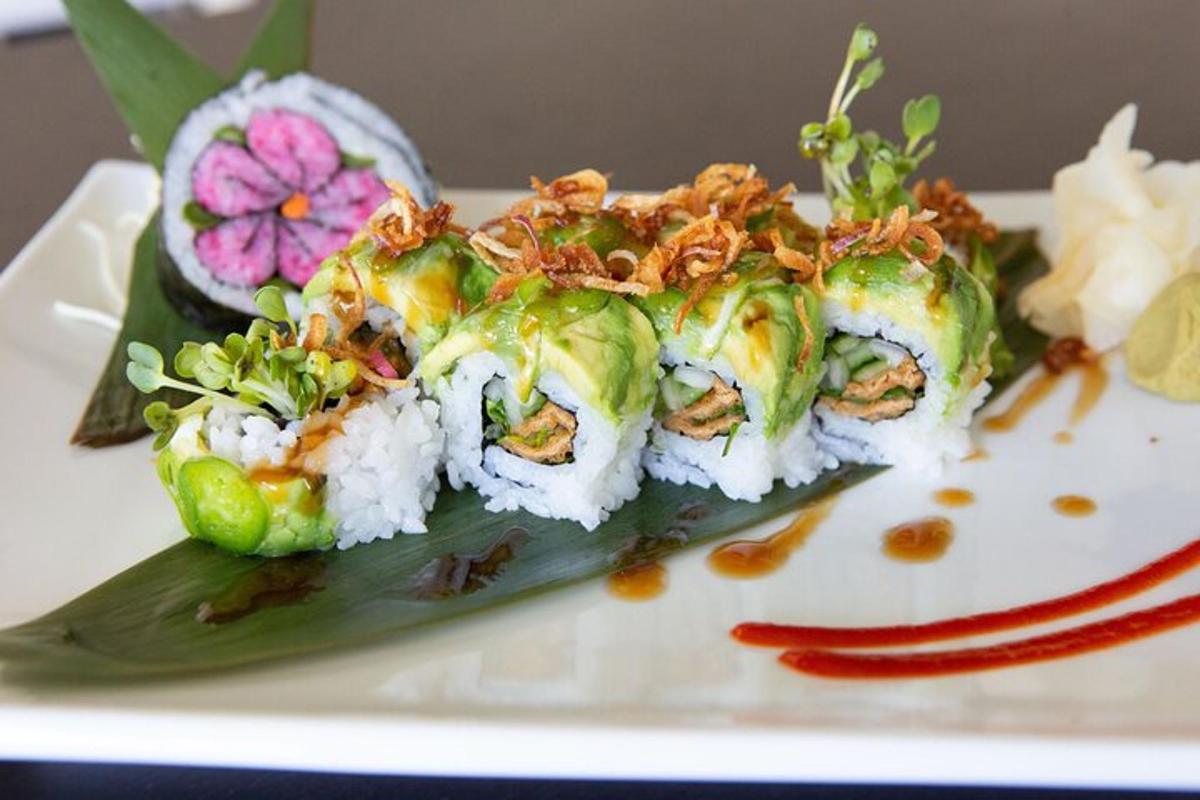 a plate of sushi with rice and vegetables on it