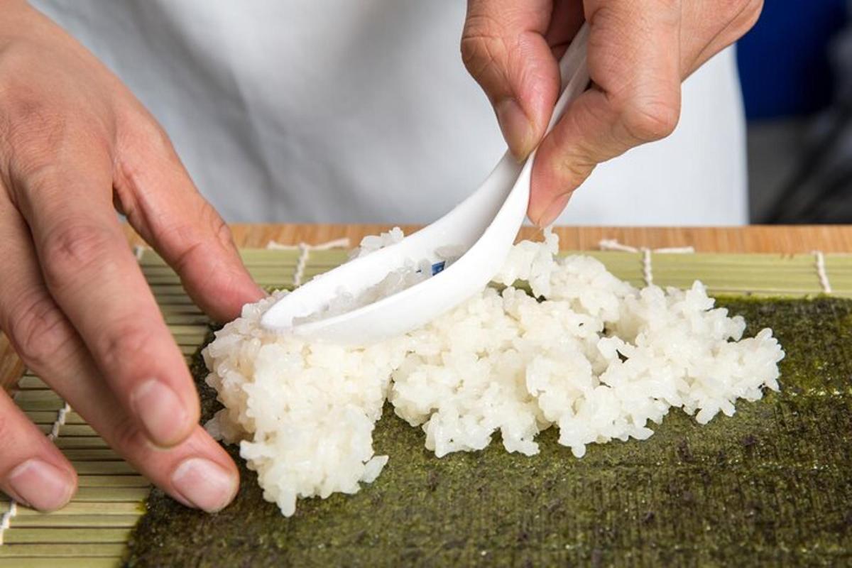a person cutting a pile of white rice with a knife