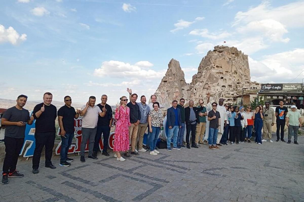 a group of people standing in front of a rock formation