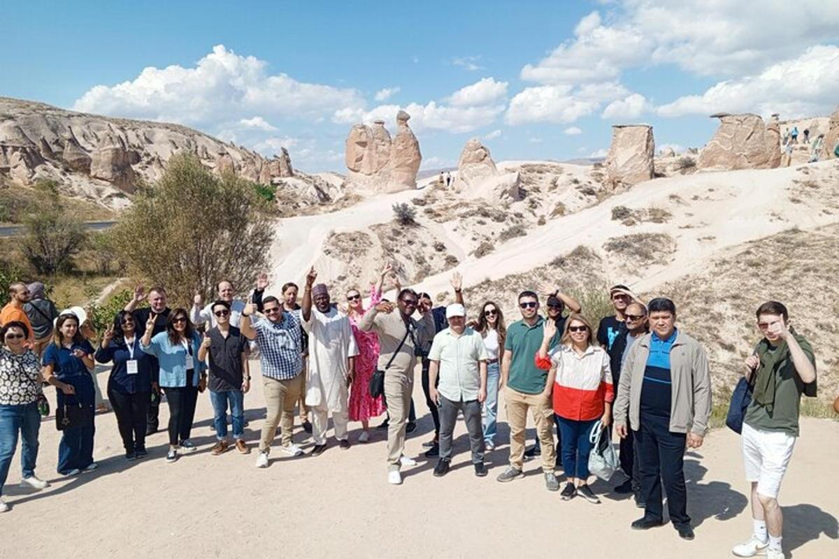 a group of people standing in front of a mountain