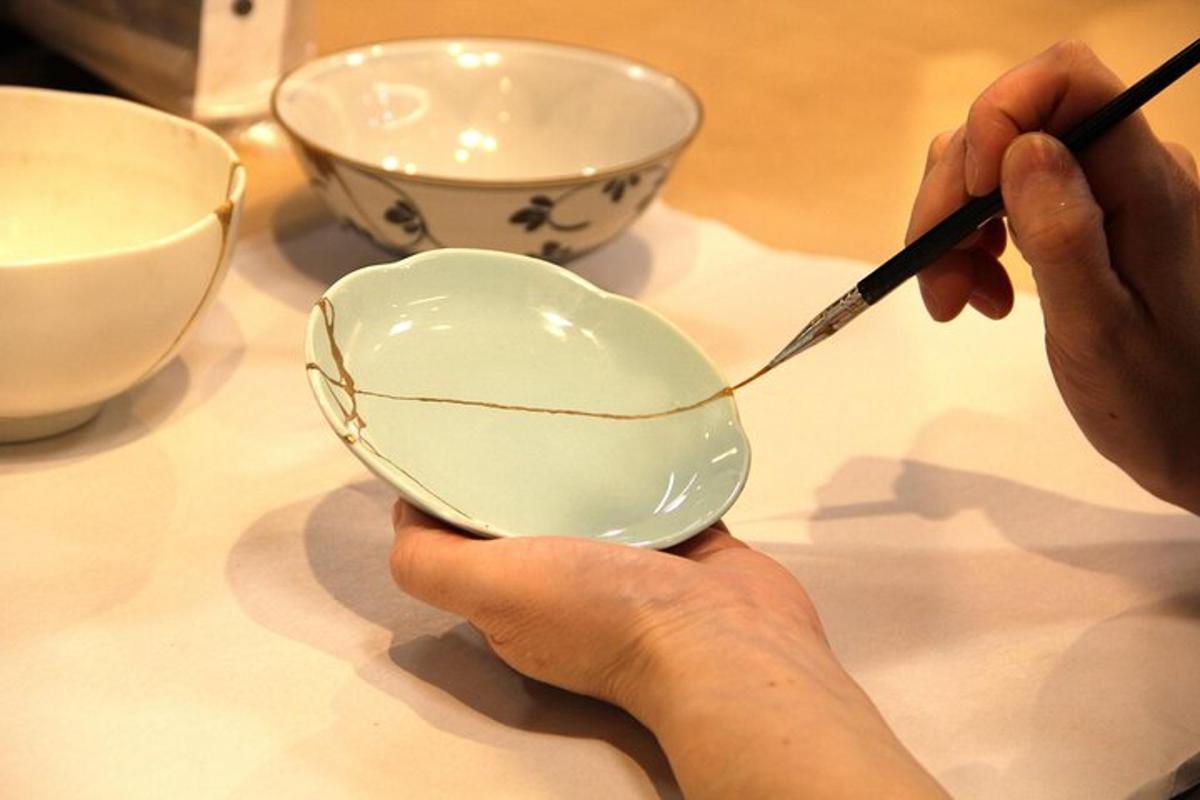 a person is cutting a bowl with a spoon