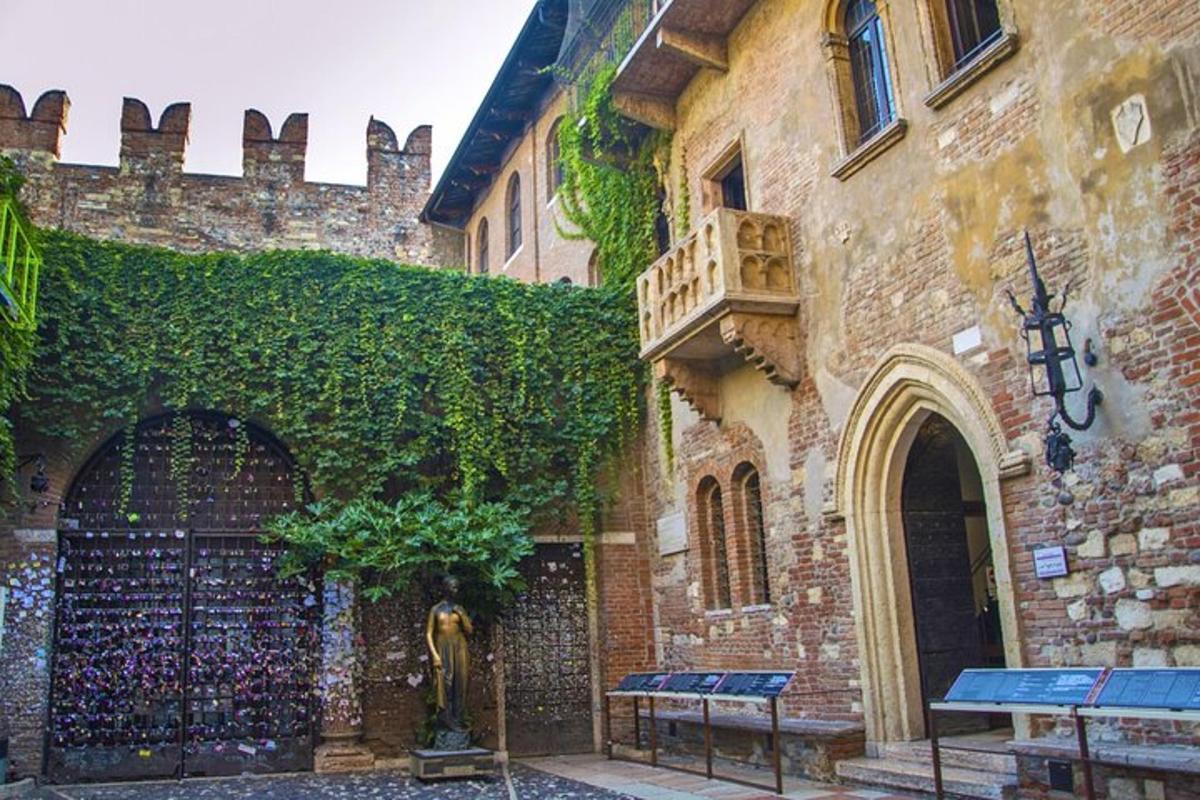 a ivy covered building with a statue in front of it