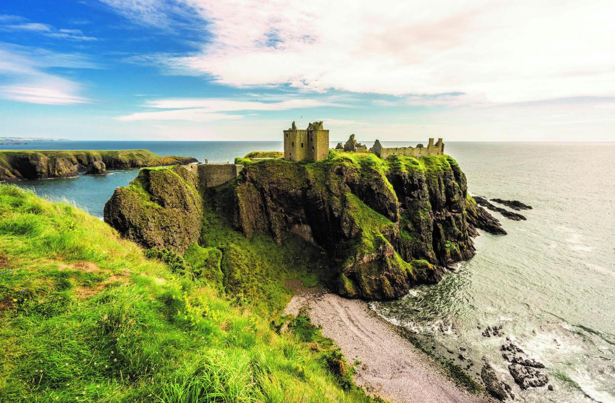 a castle on a cliff over the ocean
