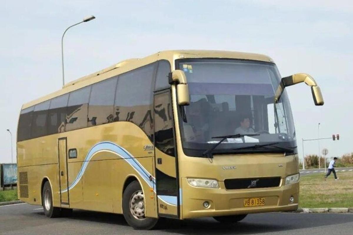 a yellow bus is driving down a street