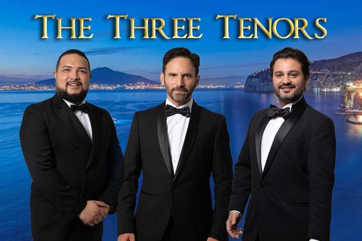 a group of three men in tuxedos posing for a picture