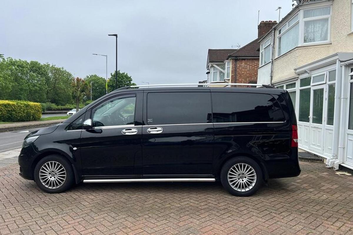 a black van parked in front of a house