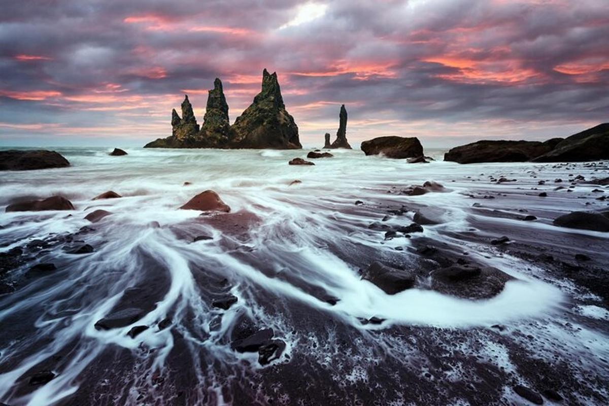 a view of a beach with rocks in the water