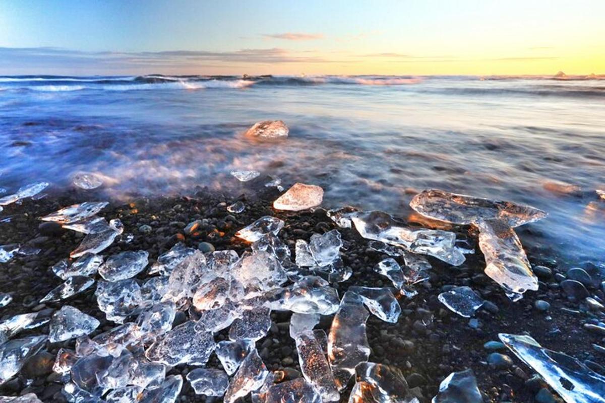 a group of rocks in the water on a beach
