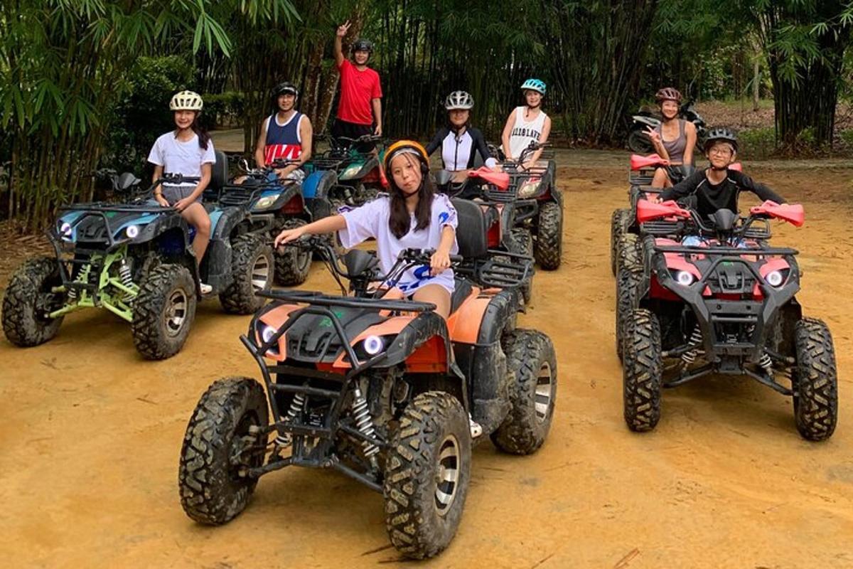 a group of people riding atvs on a dirt road