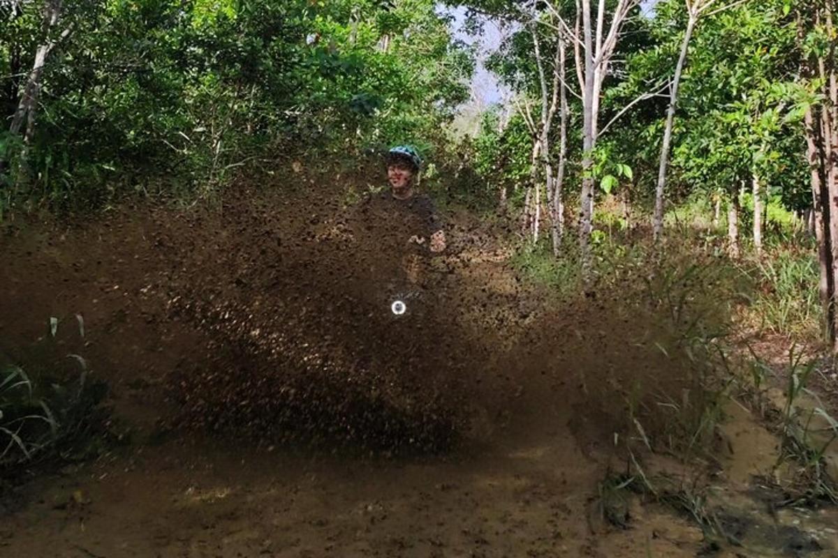 a man is kicking up dirt on a dirt road