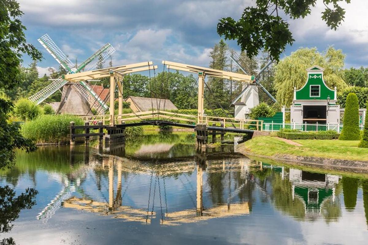 a bridge over a river with a windmill