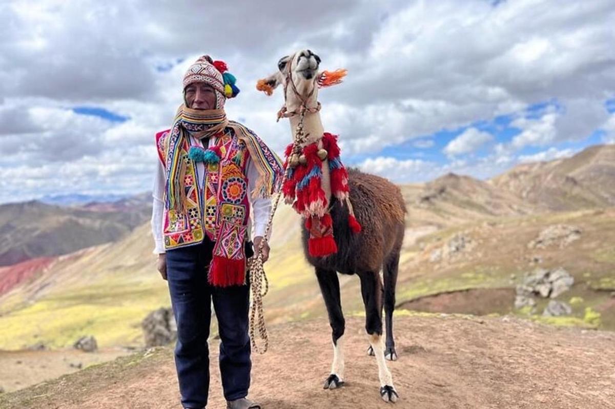 a man standing next to a camel on a mountain