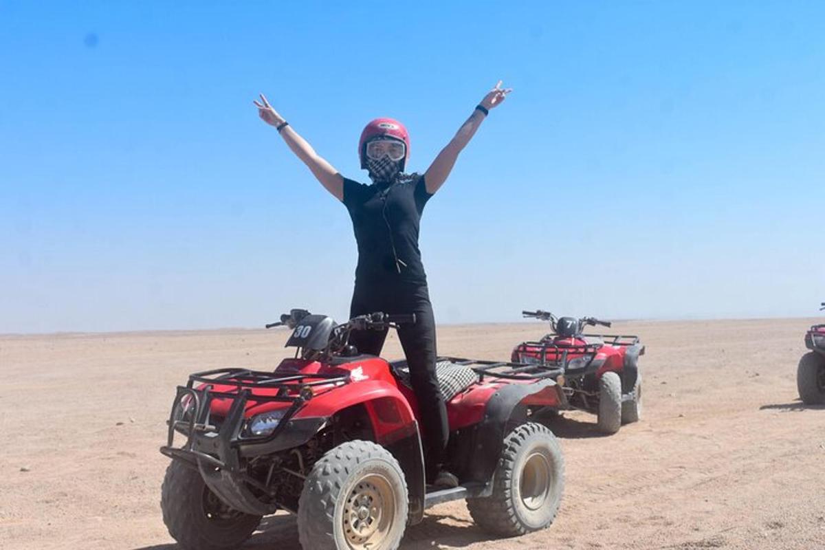 a person standing on two atvs in the desert