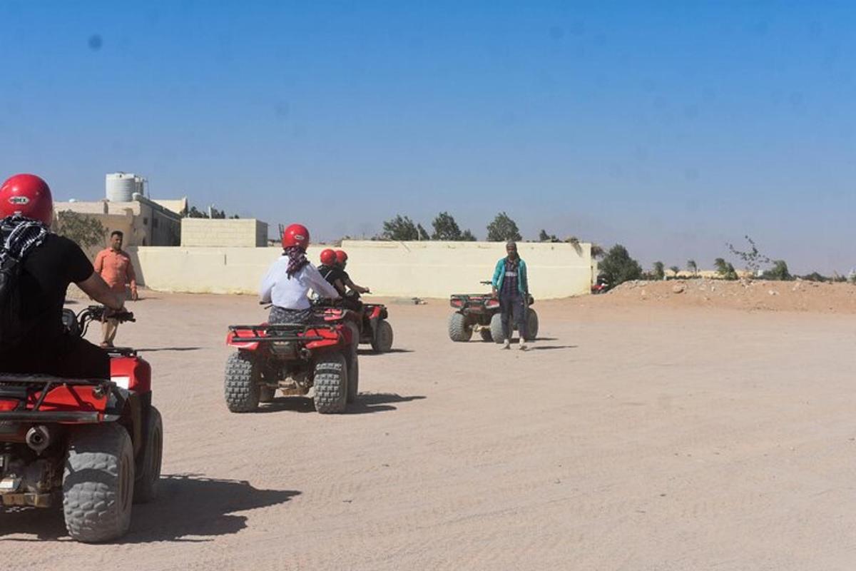 a group of people riding atvs on a dirt road