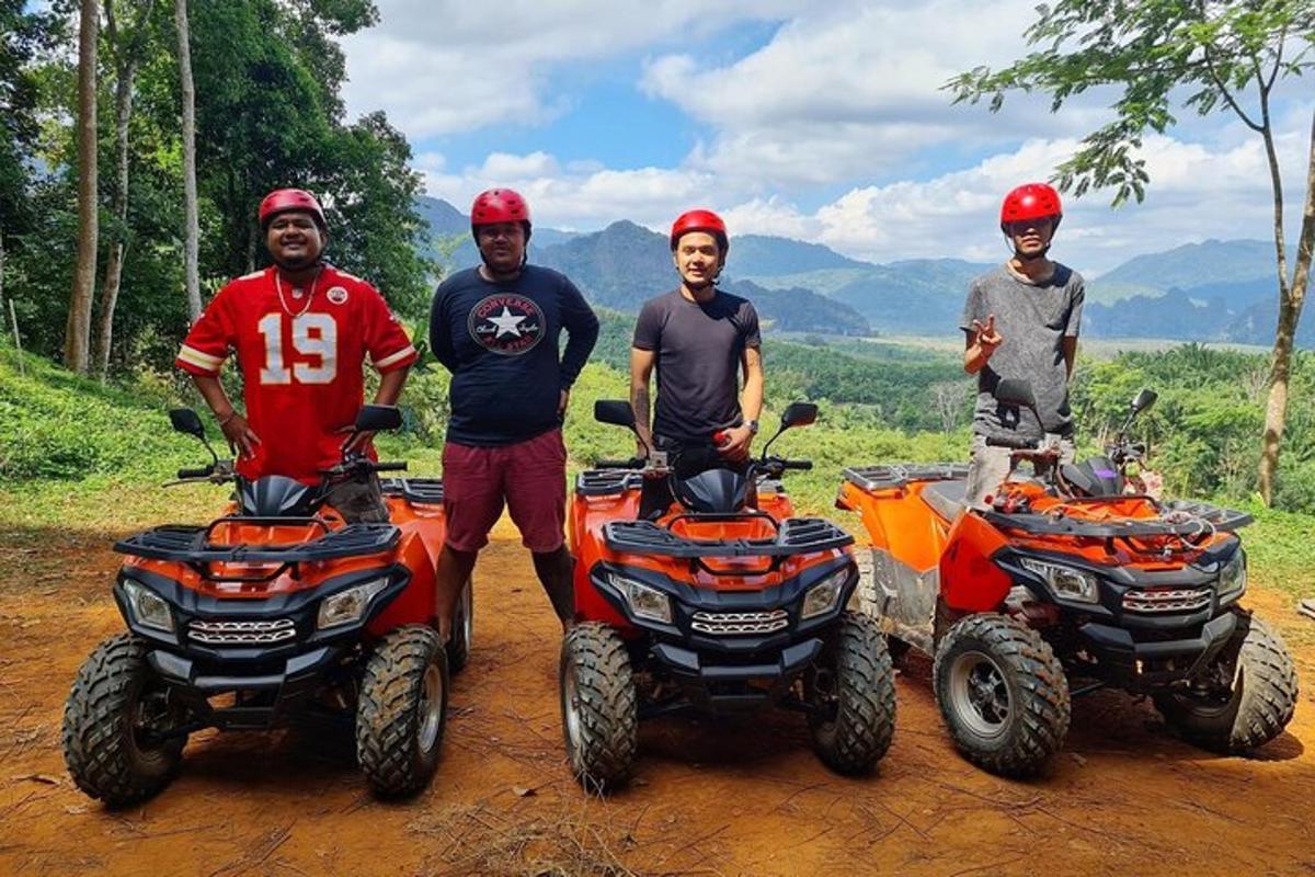 a group of three men standing next to four atvs