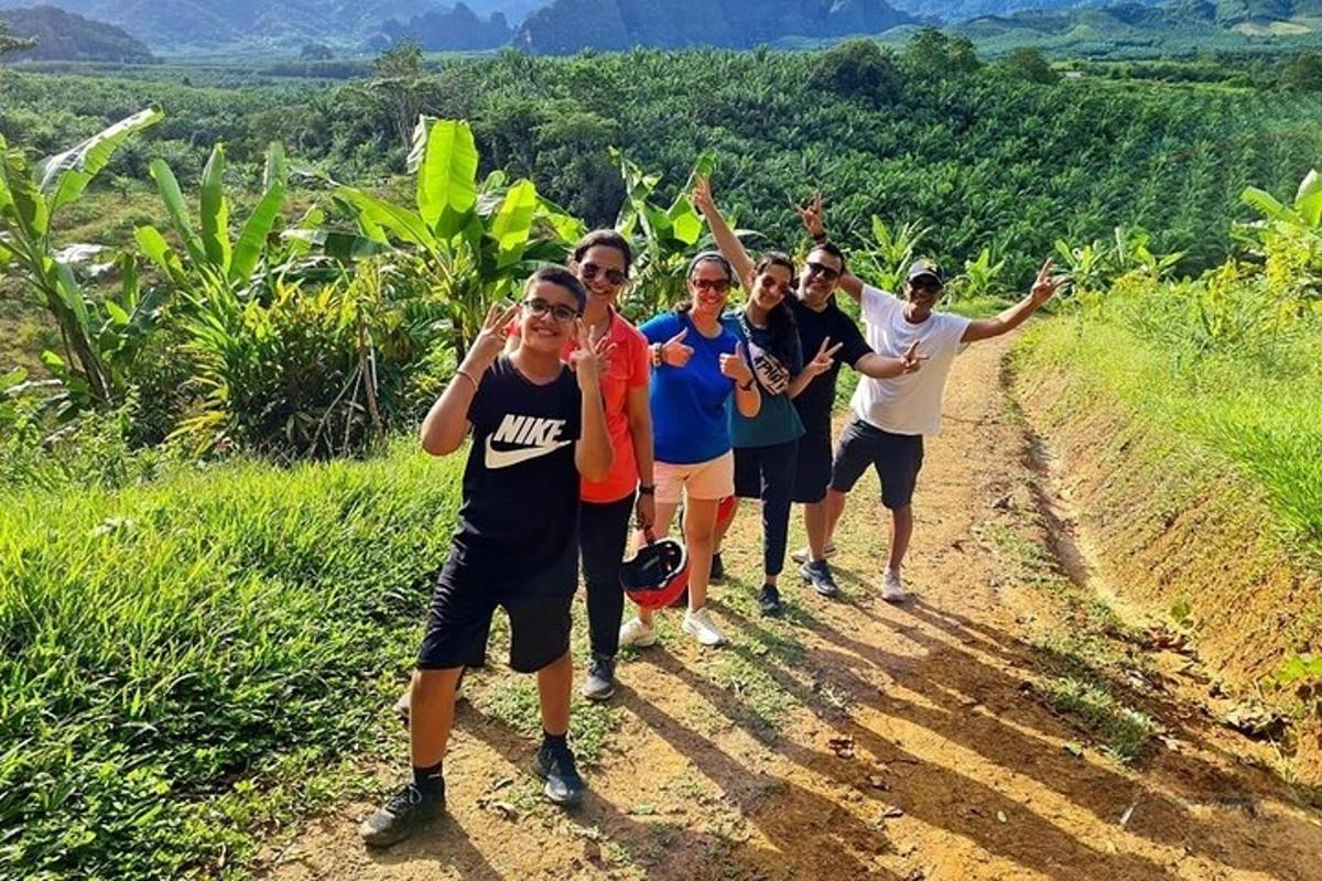 a group of people walking down a dirt road