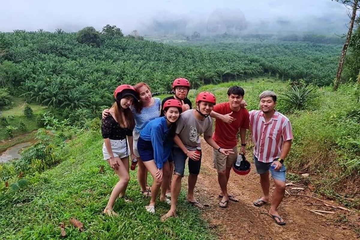 a group of people posing for a picture on a mountain