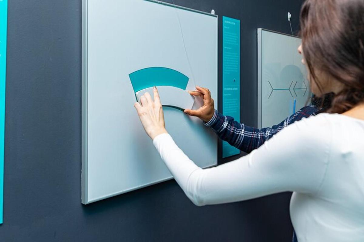 a woman is putting a book into a wall