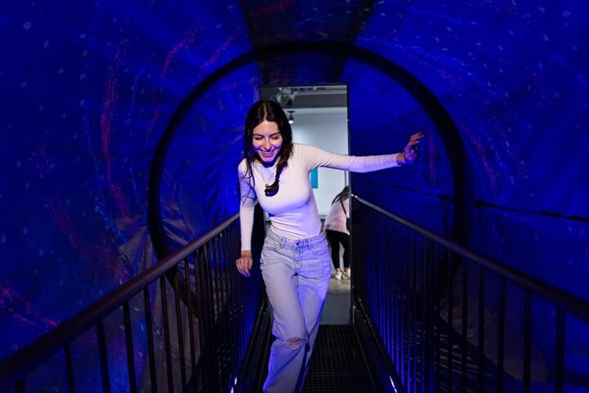 a woman walking down a staircase in a blue room