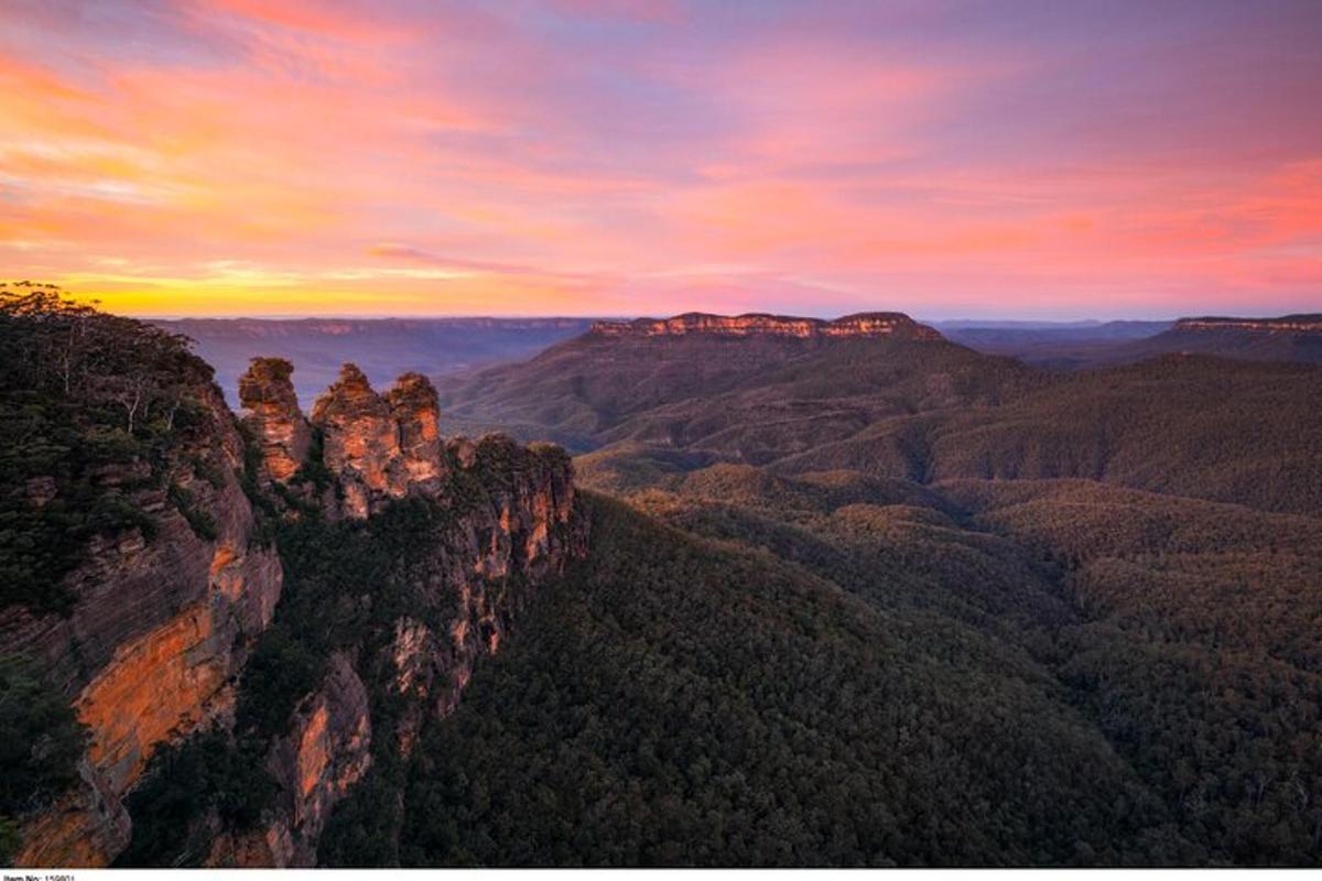 a view of the blue mountains at sunset