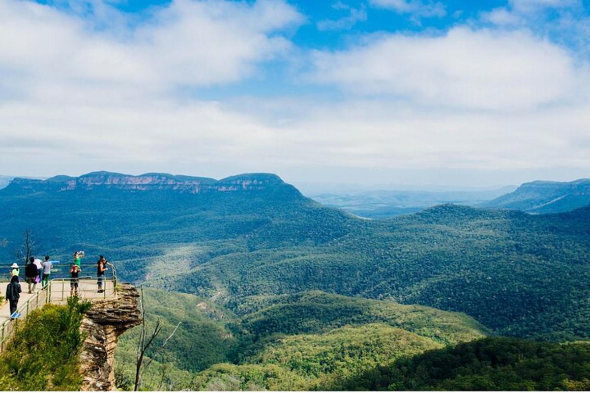 a group of people standing on the edge of a mountain