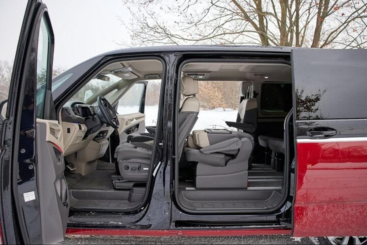an open trunk of a red van with its doors open