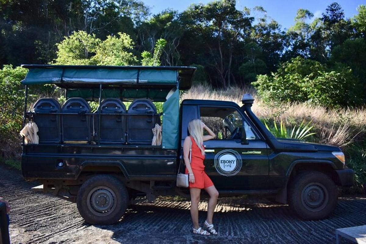 a woman standing in front of a green truck