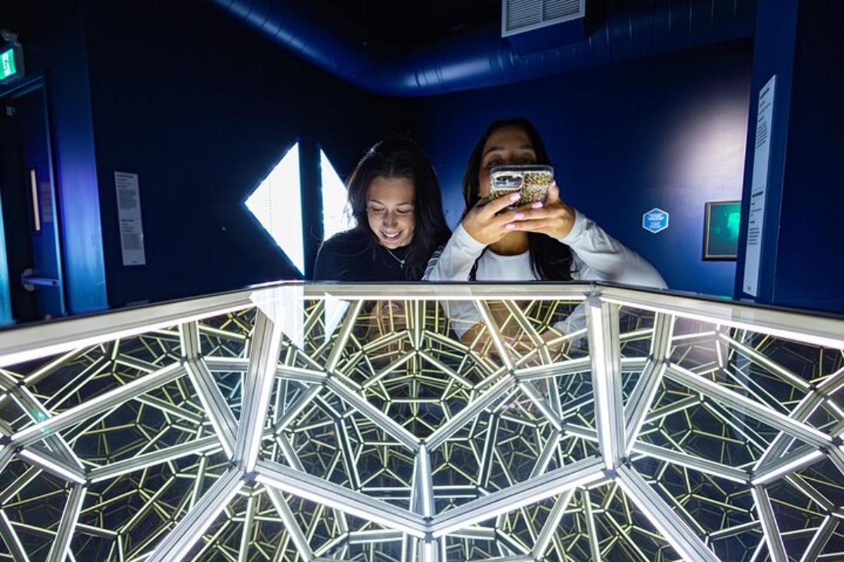 a man and a woman taking a picture in a mirror