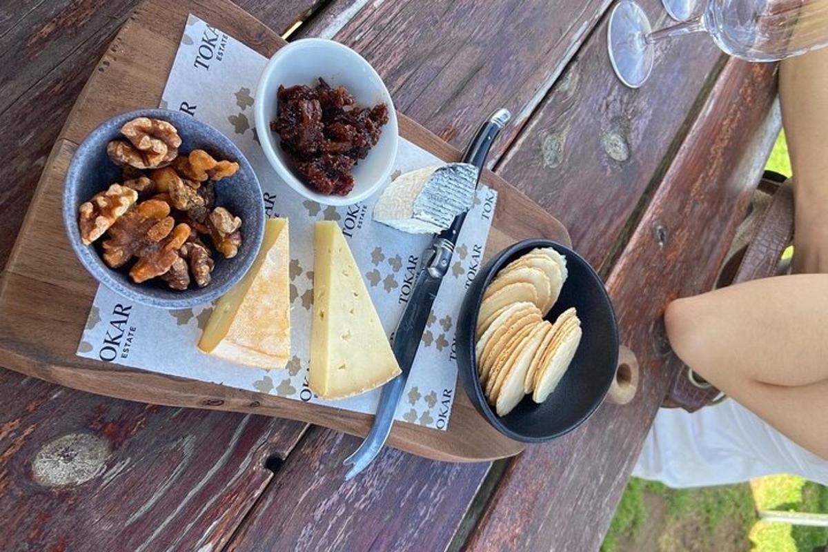 a wooden table with cheese and other food on it