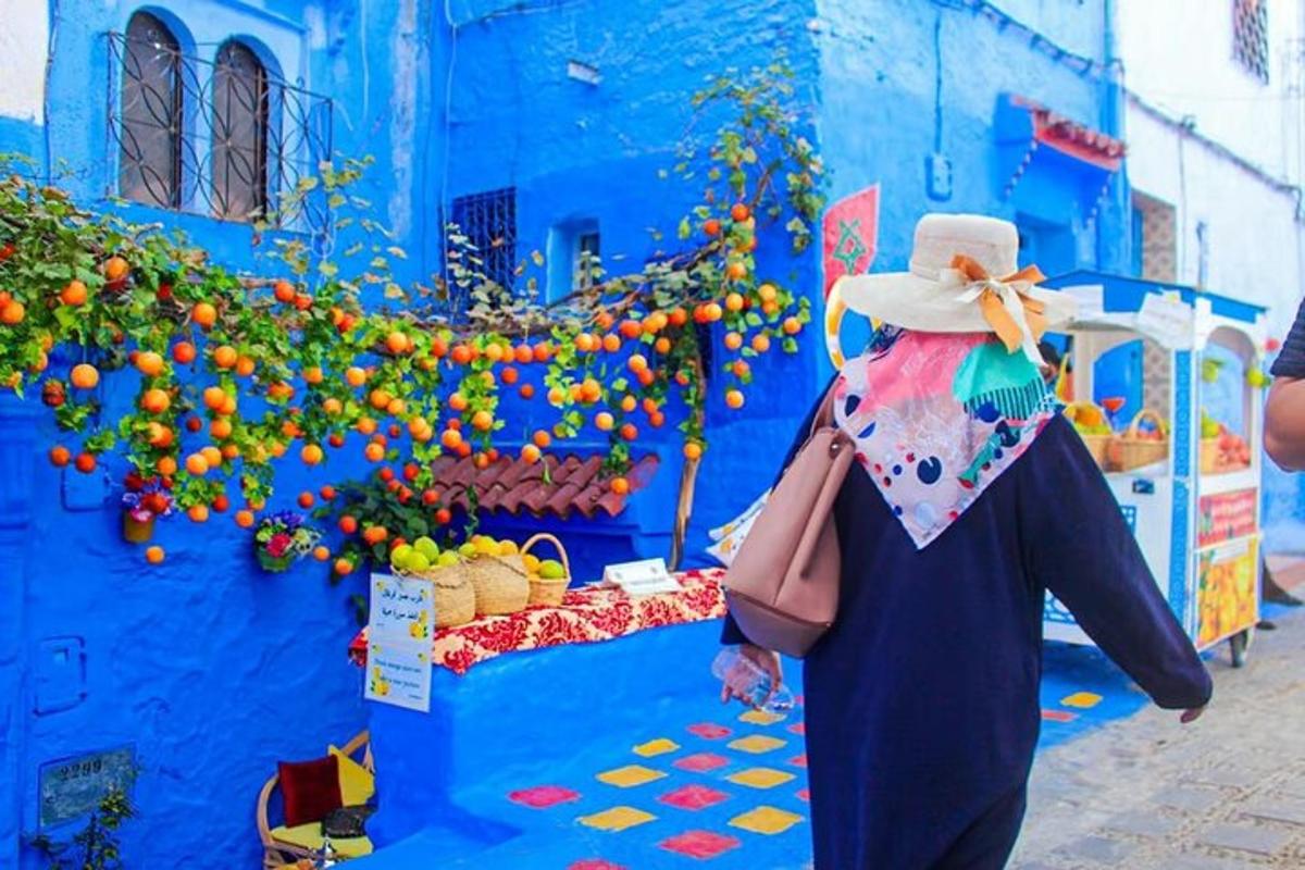 a woman standing in front of a blue building