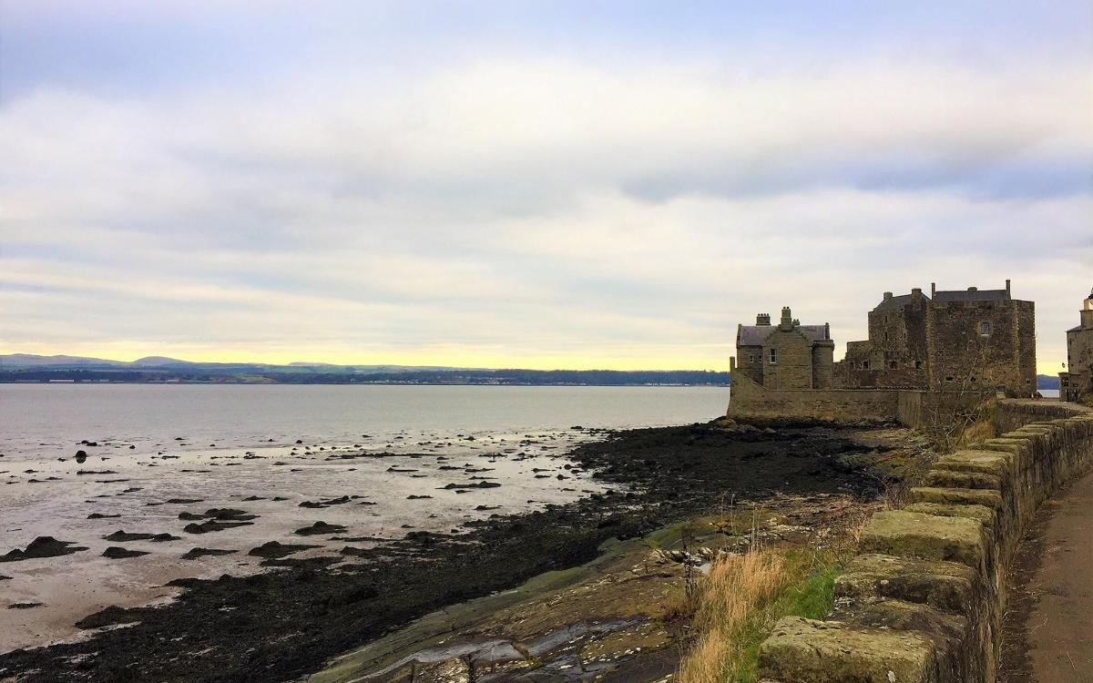a castle on the shore of a body of water