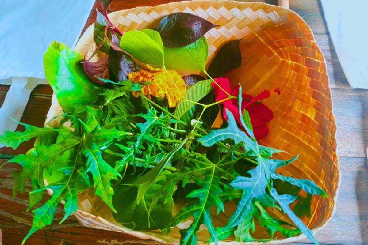 uma cesta cheia de verduras e legumes sobre uma mesa