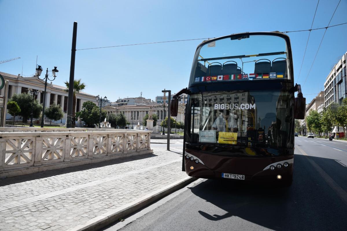 a double decker bus driving down a street