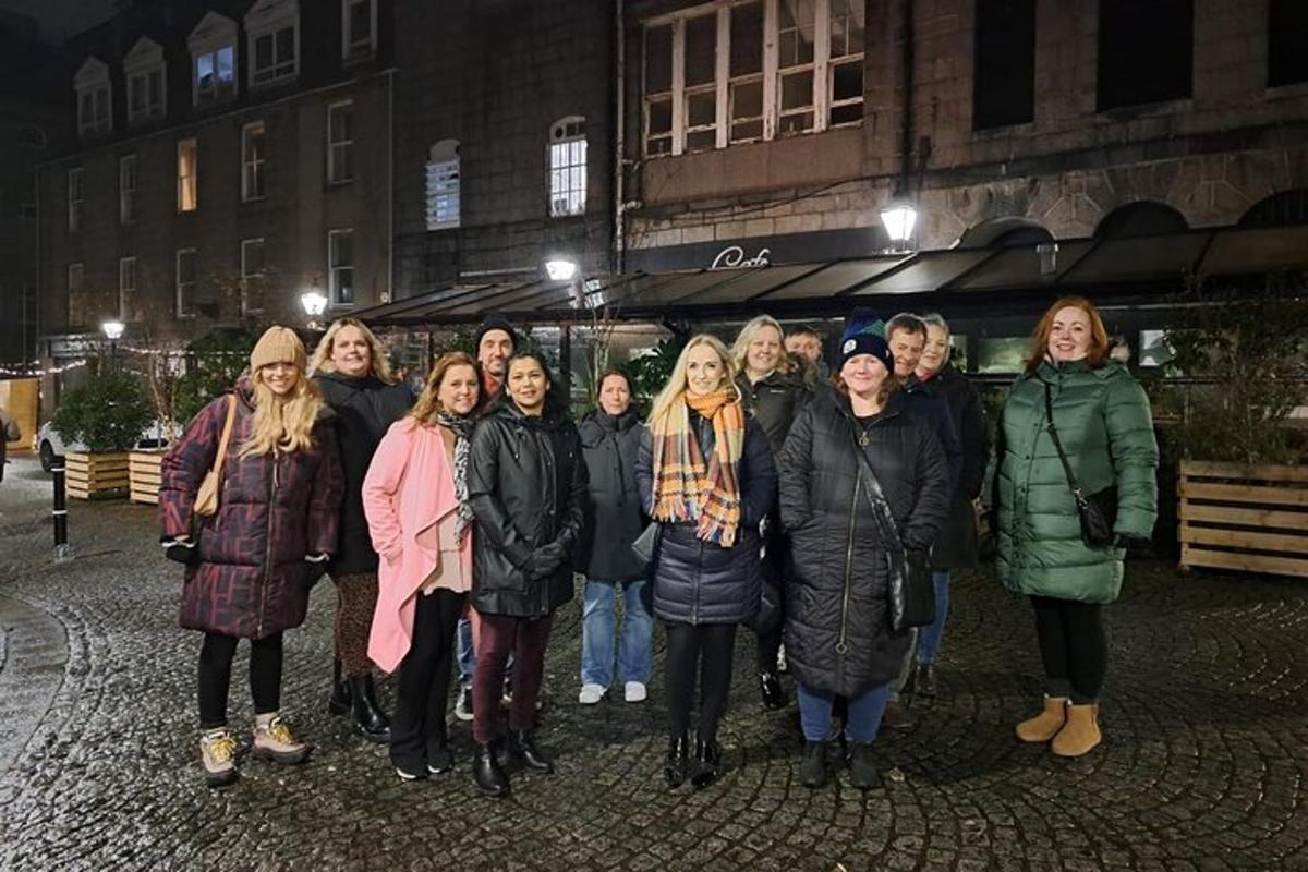 a group of people posing for a picture at night