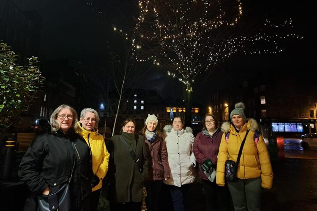 a group of women posing for a picture at night