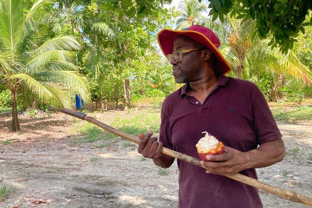 a man holding a stick and an object in his hands