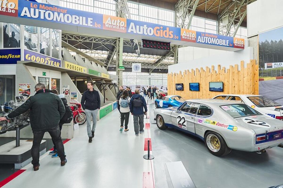sekelompok orang berjalan di sekitar pameran mobil