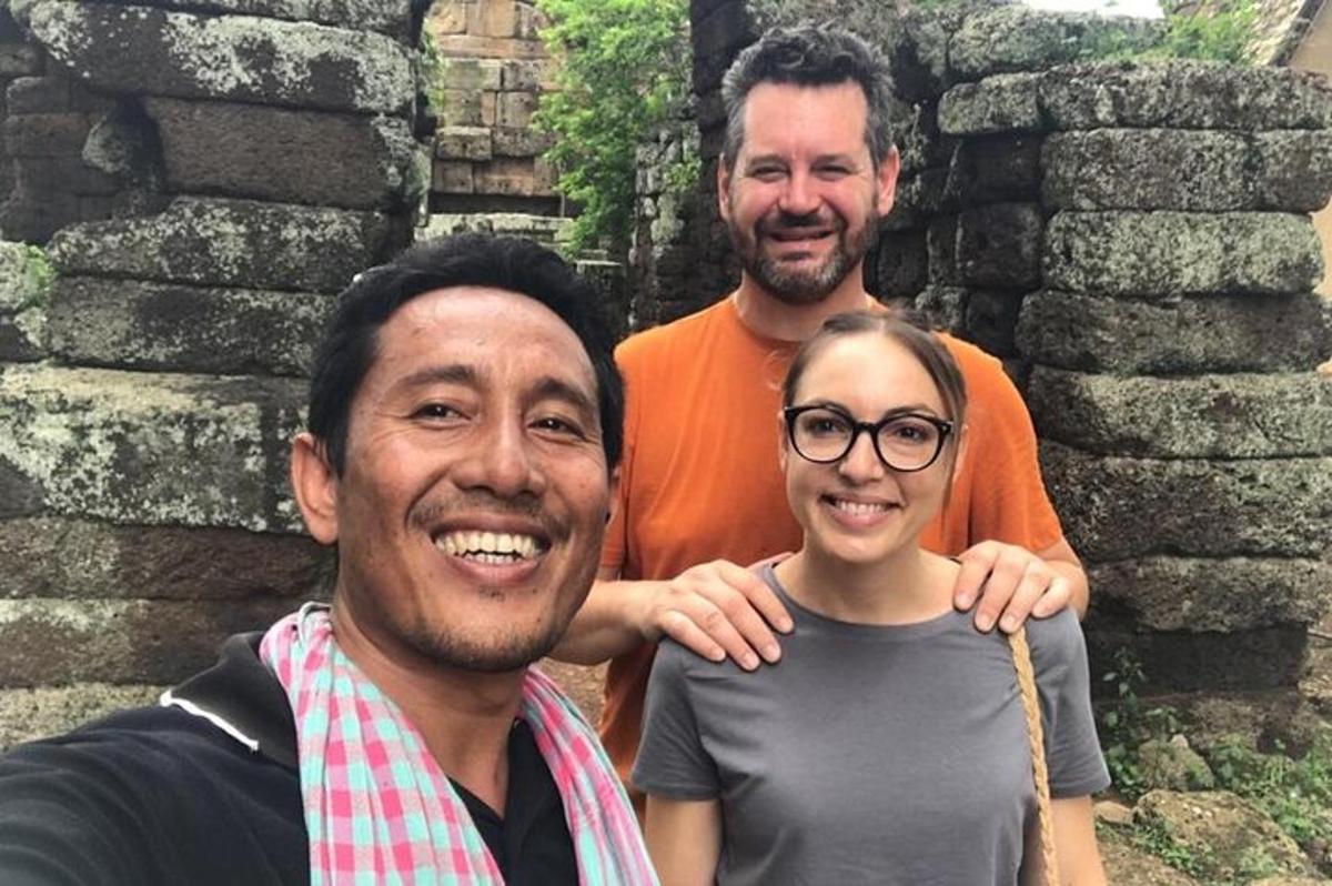 two men and a woman posing for a picture