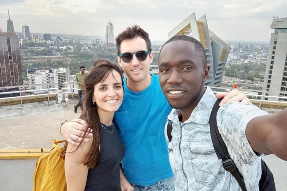 a group of people posing for a picture on top of a building