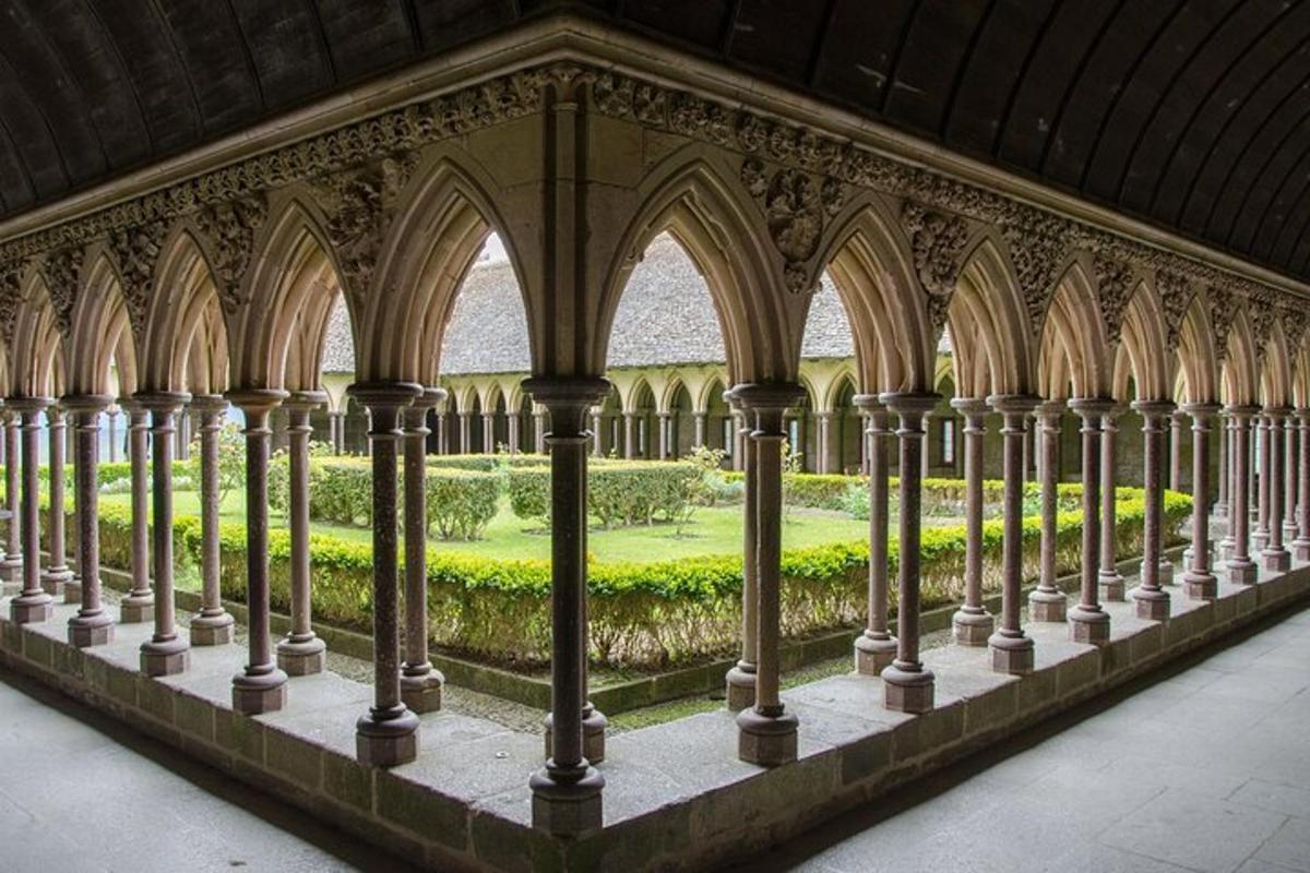 a row of columns in a building with a garden
