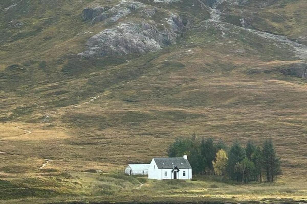 a white house in the middle of a field