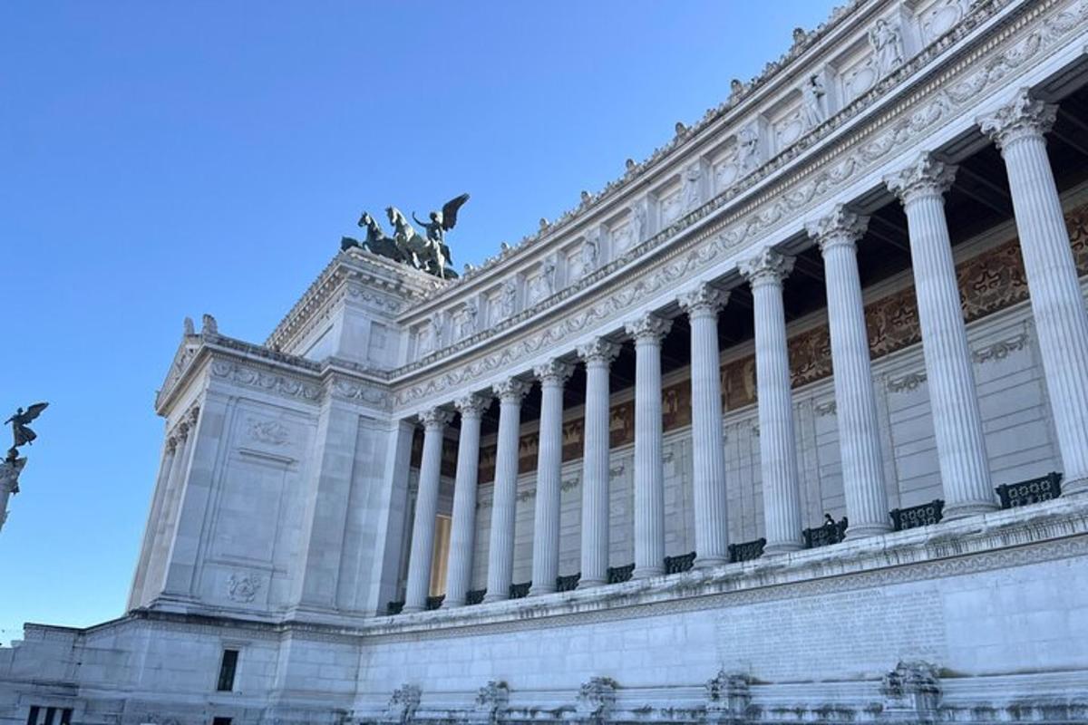 a building with columns and a statue on top