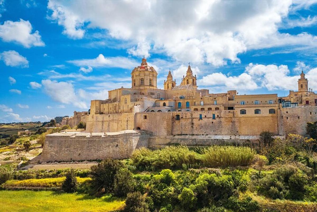 an old castle on a hill with a blue sky