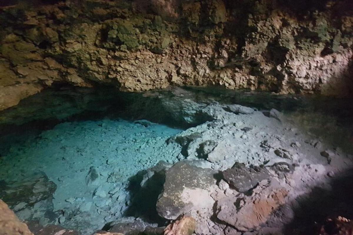 a pool of blue water in a cave