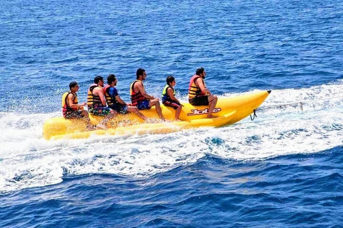 a group of people riding on a yellow raft in the water